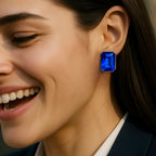 Close-up of a woman wearing a blue gemstone earring.