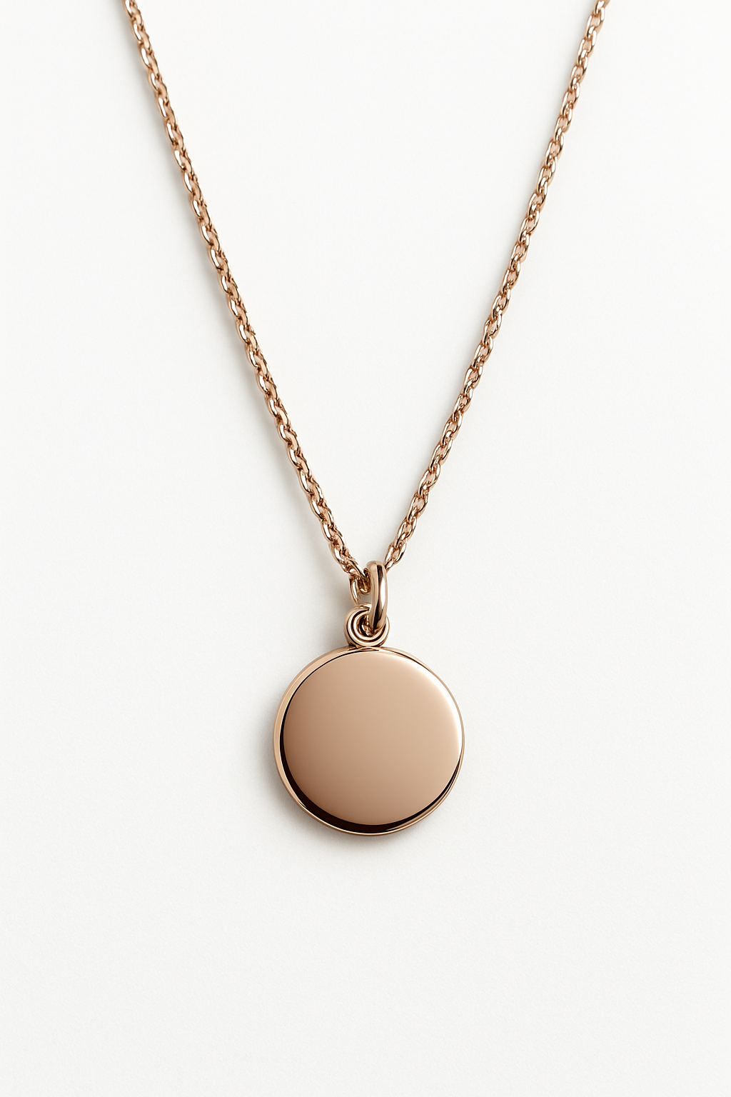 Rose gold necklace with a round pendant on a white background