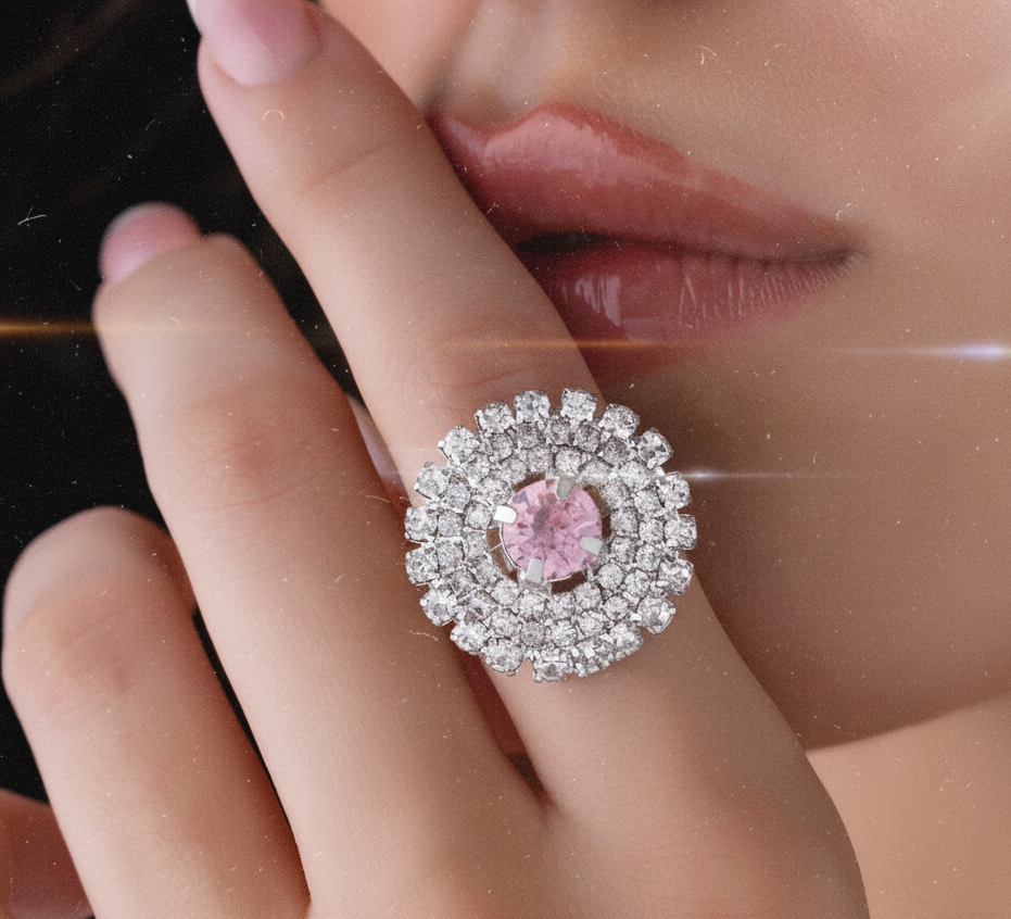 Close-up of a hand wearing a ring with a pink gemstone and diamond accents.