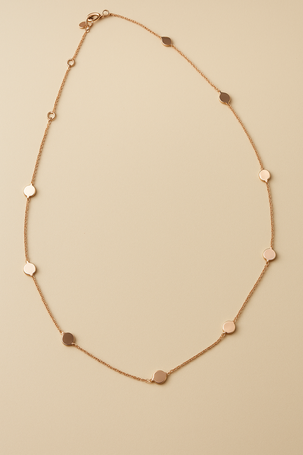 polka dots Rose gold necklace  on a beige background