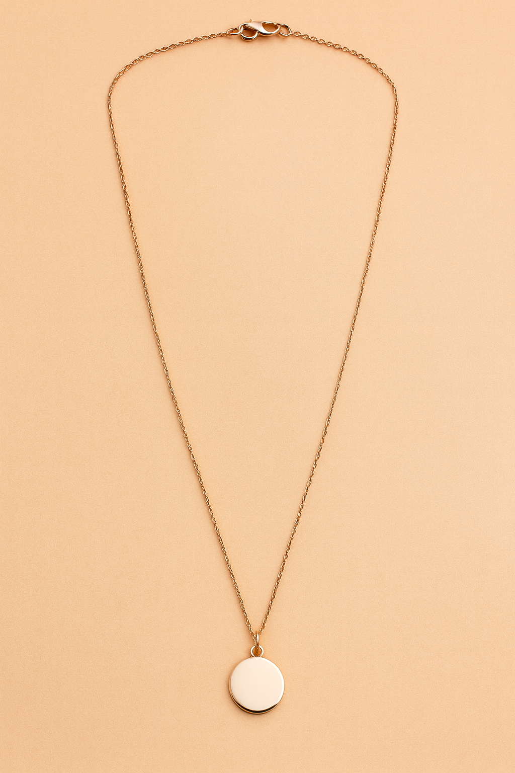 Necklace with a black pendant on a beige background