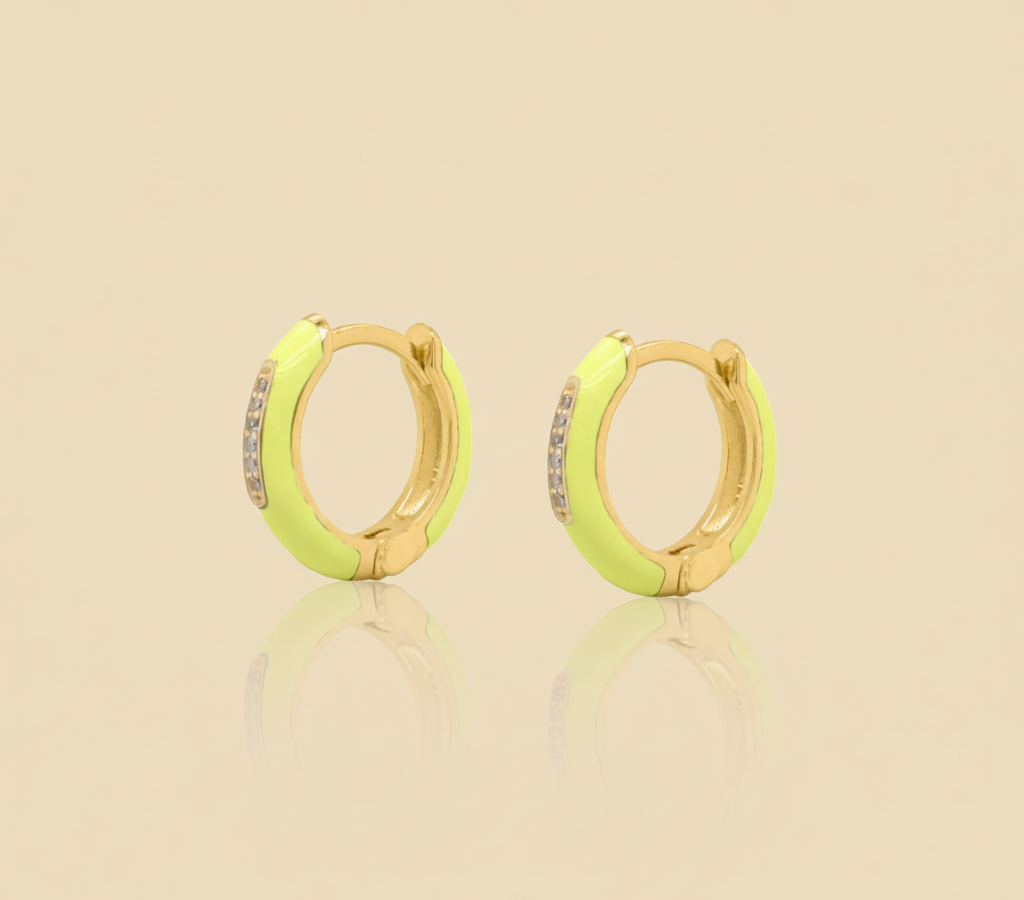 Pair of neon yellow hoop earrings with gold accents on a beige background