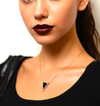 Woman wearing a gold necklaceSterling Silver Gold Vermeil CZ Geometric Triangle Necklace