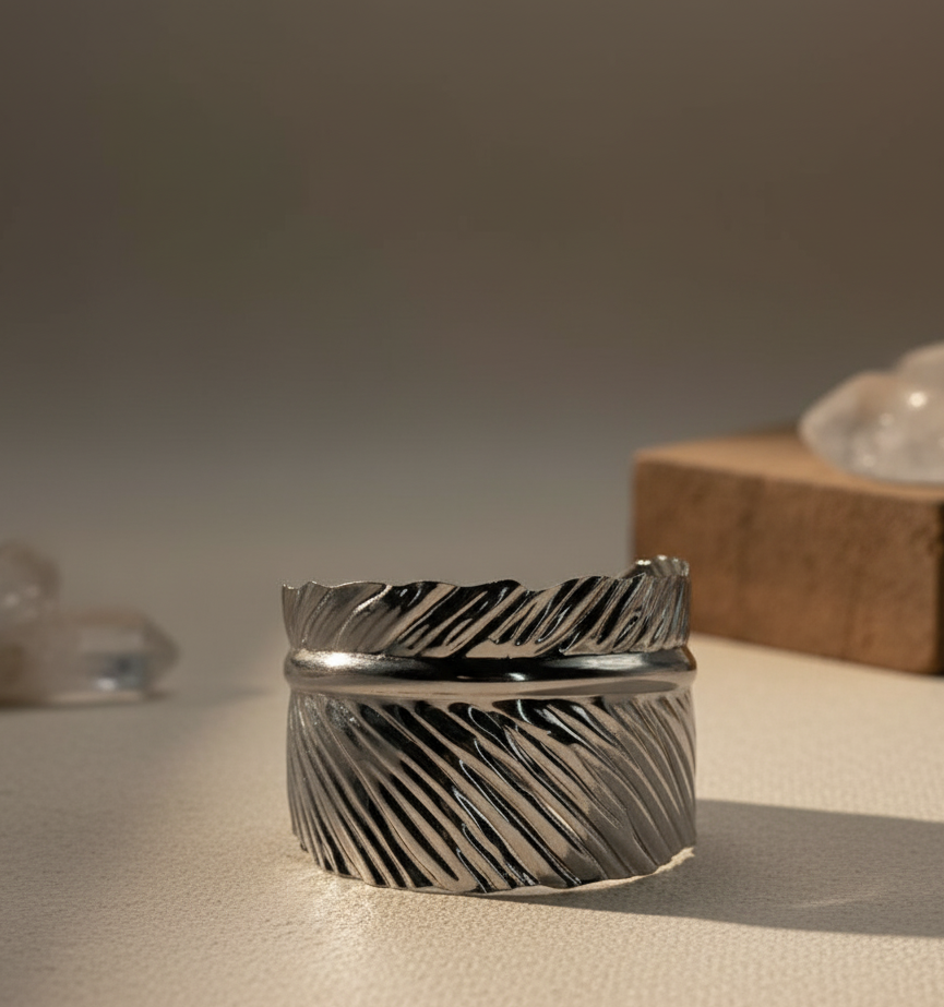 Close-up of an anti  tarnish adjustable  leaf textured silver cuff on plain background.