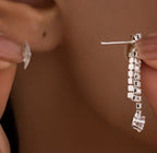 Close-up of rhinestone dangle earrings from the triple-layer necklace set.